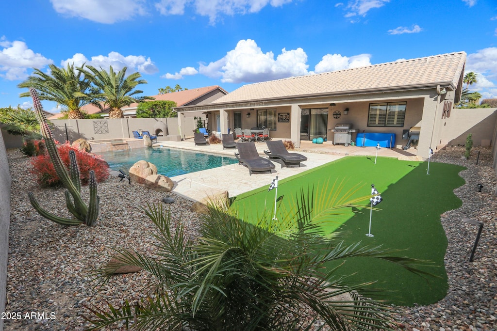 view of pool featuring a hot tub, a patio, and grilling area