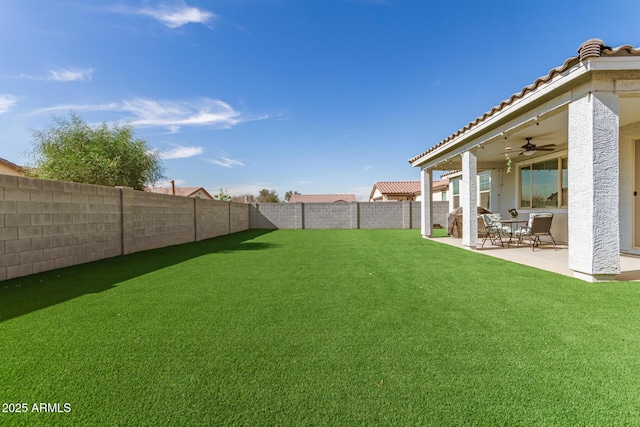 view of yard with ceiling fan and a patio area