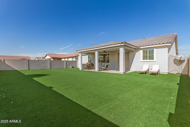 back of house with a lawn, a patio, and ceiling fan