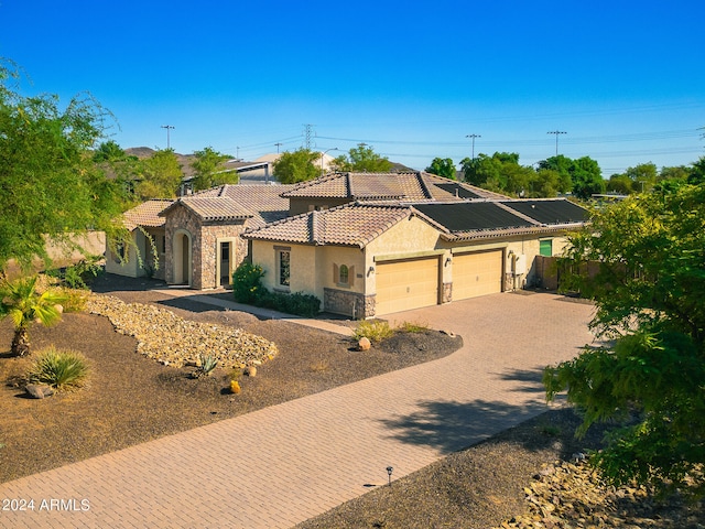 mediterranean / spanish house with a garage