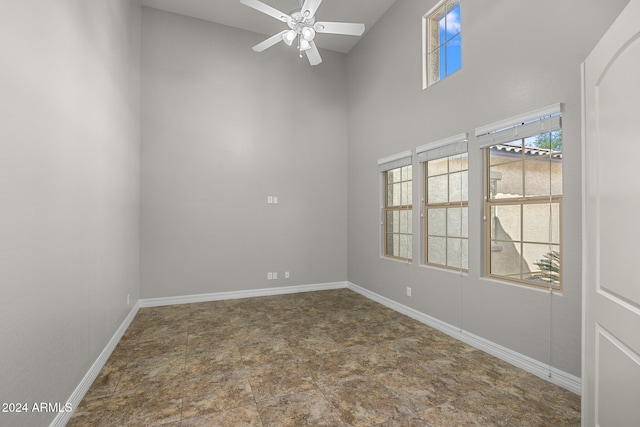 spare room with ceiling fan and a towering ceiling