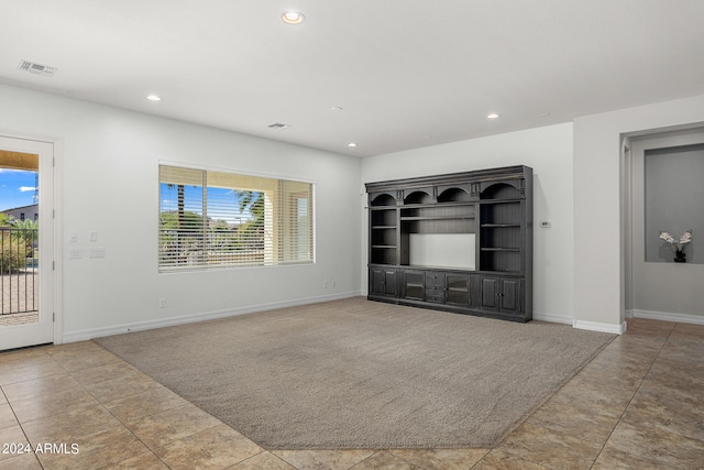 unfurnished living room with plenty of natural light and light tile patterned floors