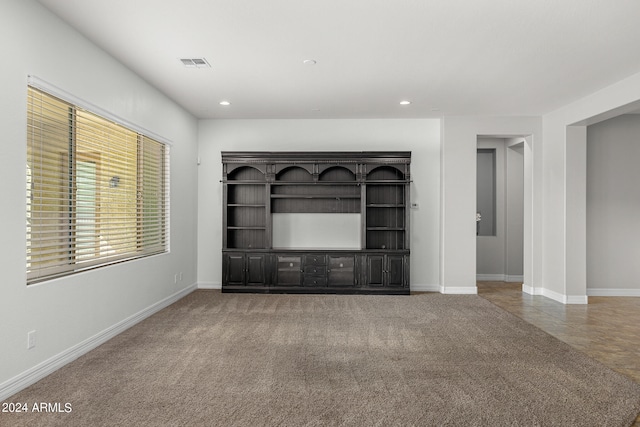 unfurnished living room with carpet flooring