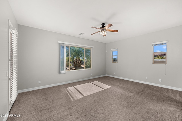 unfurnished bedroom featuring multiple windows, carpet, and ceiling fan