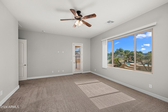 empty room featuring carpet floors and ceiling fan