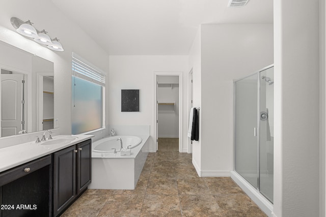 bathroom featuring vanity and shower with separate bathtub