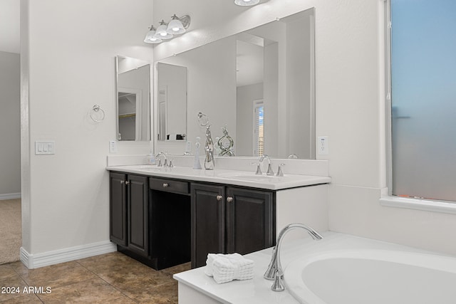 bathroom with vanity, a bathtub, and tile patterned flooring