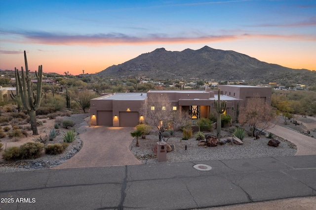 view of front of home featuring a mountain view and a garage