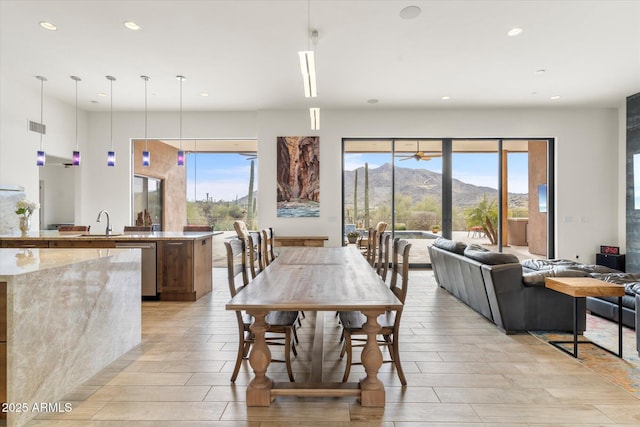 dining room with plenty of natural light, a mountain view, and sink