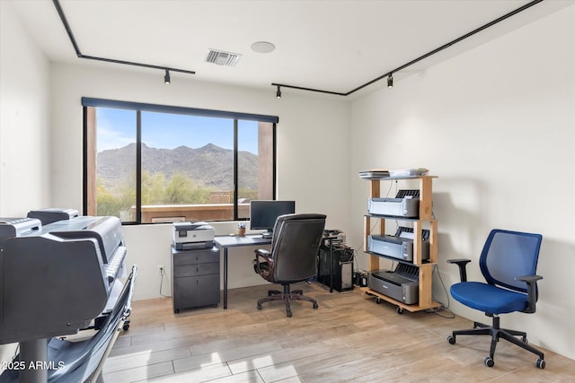 office area featuring rail lighting and light hardwood / wood-style floors