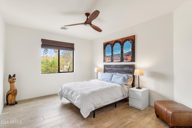 bedroom with light hardwood / wood-style flooring and ceiling fan