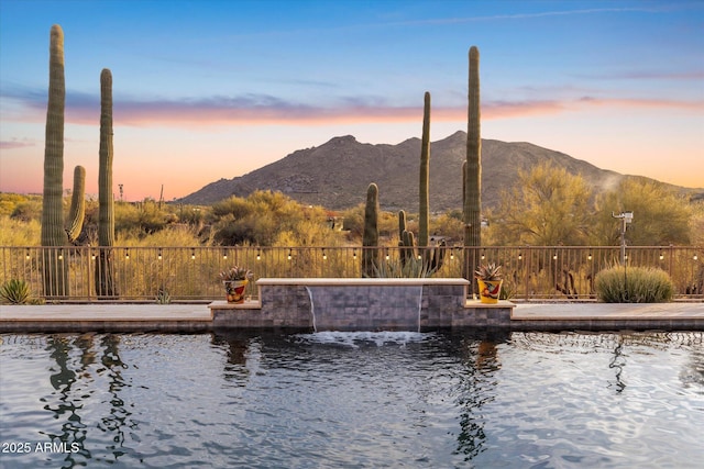 pool at dusk with a mountain view