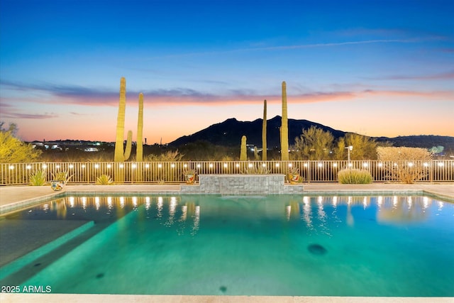 pool at dusk with a mountain view