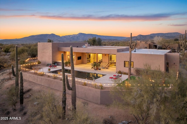 view of front facade with a mountain view and a patio area