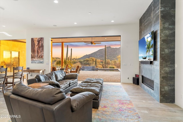 living room with a large fireplace and light wood-type flooring