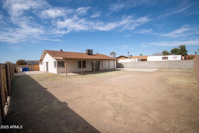 rear view of property featuring cooling unit and a patio area