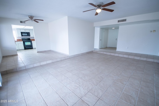 spare room featuring light tile patterned flooring and ceiling fan