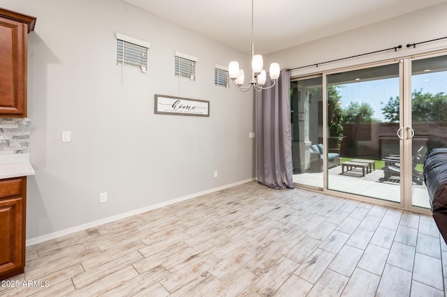 2611 S Quaintance St, Gilbert, AZ 85295 - dining room with light wood-style flooring, a chandelier, and baseboards