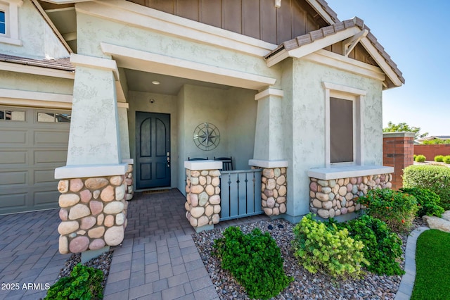 2611 S Quaintance St, Gilbert, AZ 85295 - doorway to property with stone siding, board and batten siding, stucco siding, and covered porch
