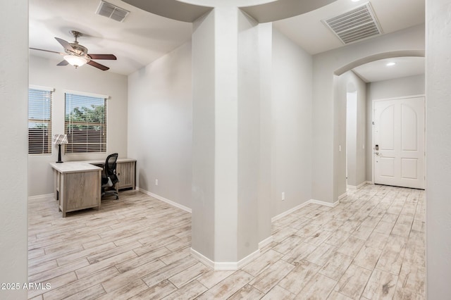 2611 S Quaintance St, Gilbert, AZ 85295 - unfurnished office featuring arched walkways, light wood-type flooring, a ceiling fan, and baseboards
