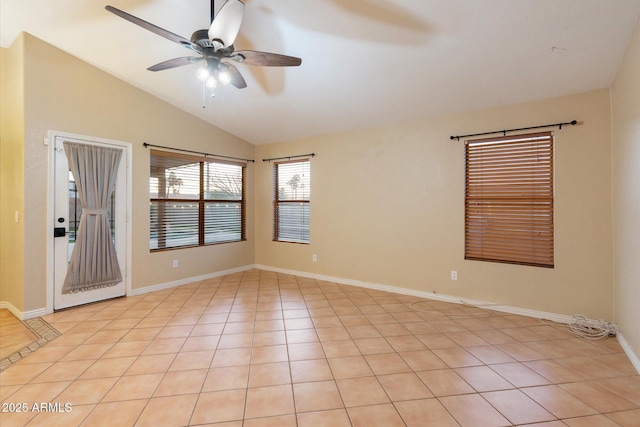 empty room featuring vaulted ceiling, light tile patterned floors, and ceiling fan