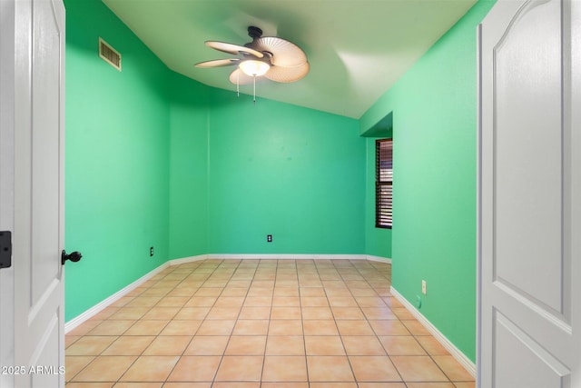 tiled spare room with lofted ceiling and ceiling fan