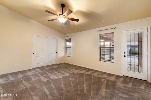 unfurnished bedroom featuring ceiling fan, lofted ceiling, access to outside, and dark carpet