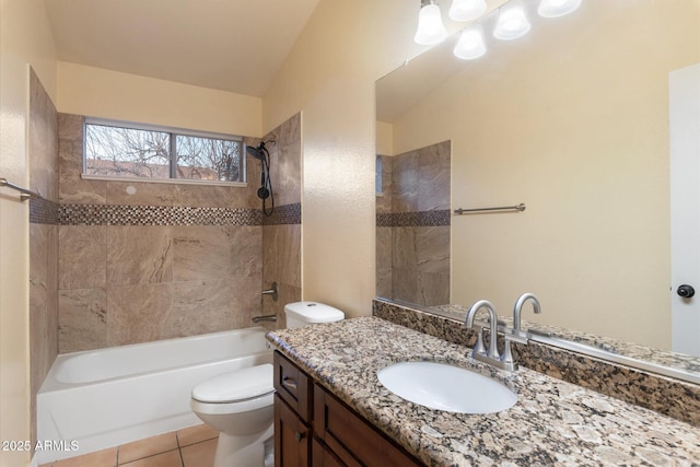 full bathroom with vanity, tiled shower / bath, tile patterned floors, and toilet