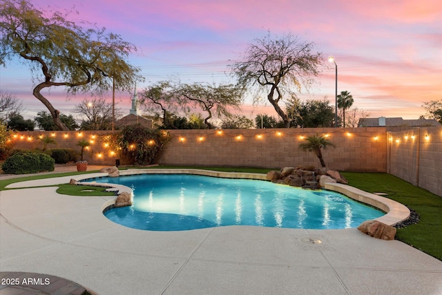 pool at dusk with a patio