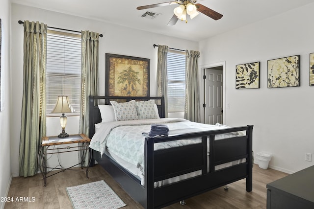 bedroom with ceiling fan and hardwood / wood-style flooring