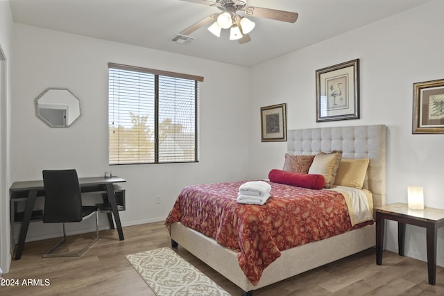 bedroom with light hardwood / wood-style floors and ceiling fan