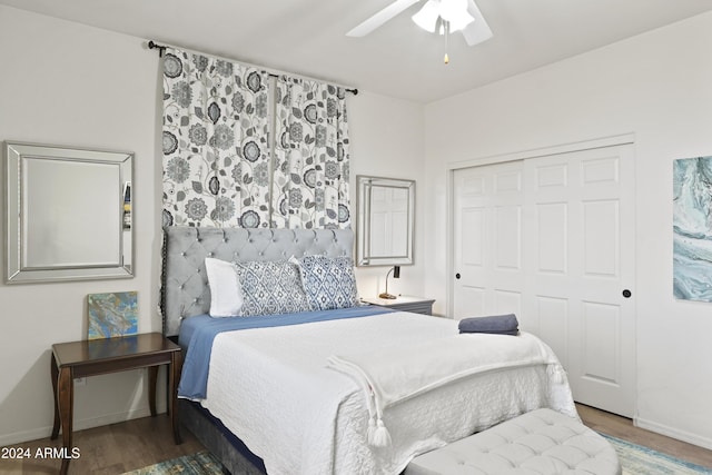 bedroom with ceiling fan, a closet, and hardwood / wood-style floors