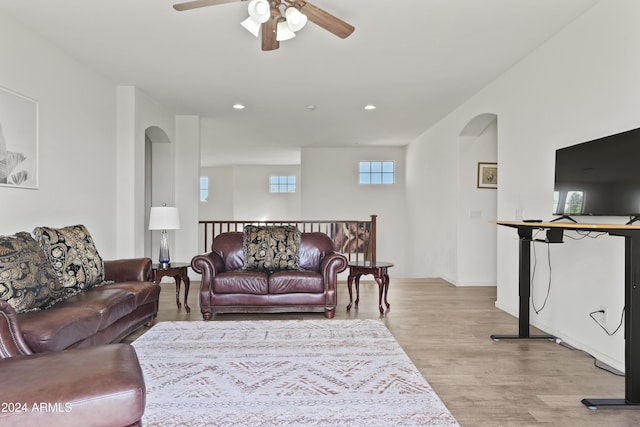 living room with ceiling fan and light hardwood / wood-style floors