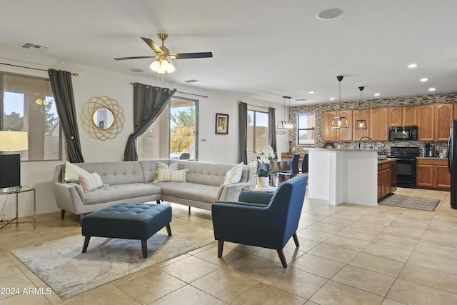 tiled living room with ceiling fan