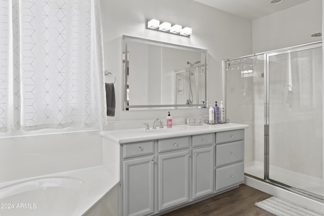 bathroom featuring vanity, hardwood / wood-style flooring, and independent shower and bath