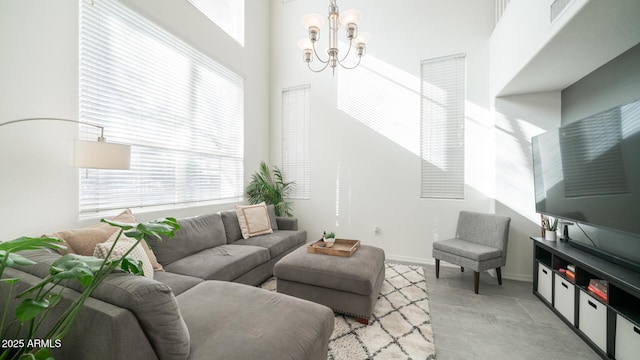 living room with a high ceiling and a chandelier