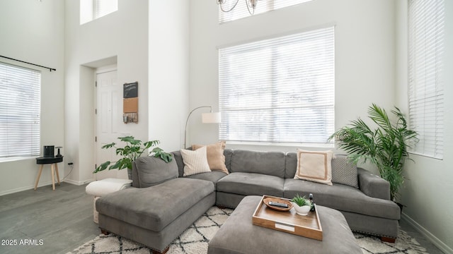 living room featuring light hardwood / wood-style floors and a towering ceiling