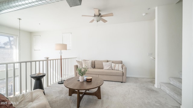 carpeted living room featuring ceiling fan