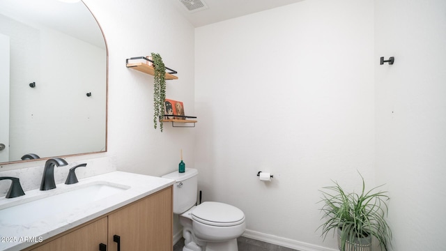 bathroom featuring toilet and vanity