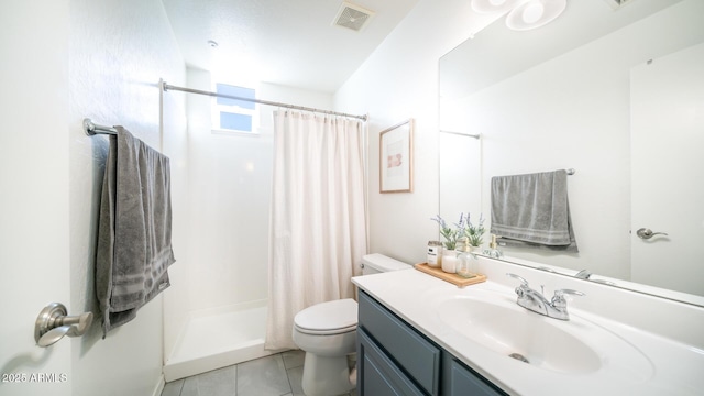 bathroom featuring toilet, vanity, tile patterned floors, and walk in shower