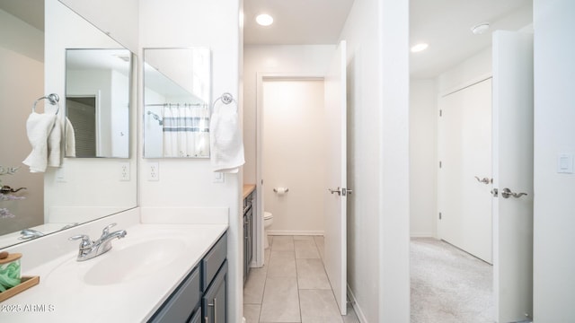 bathroom featuring toilet, tile patterned flooring, and vanity