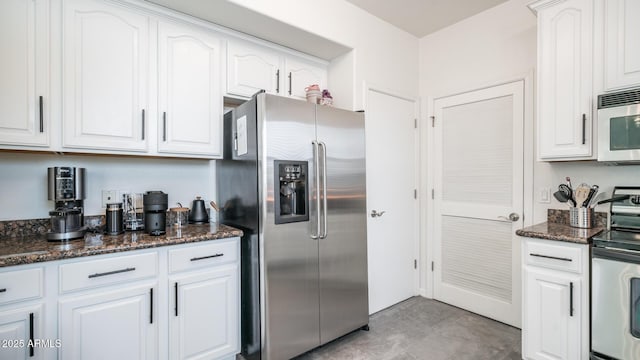 kitchen with white cabinets, appliances with stainless steel finishes, and dark stone countertops