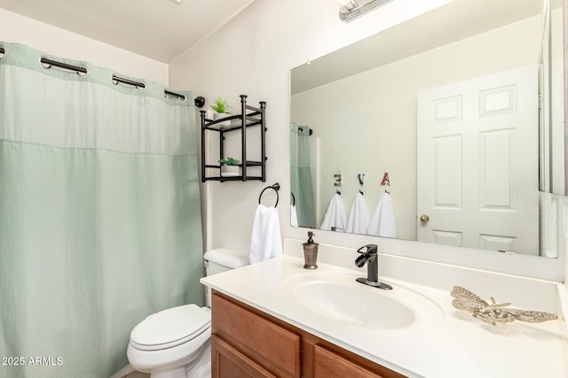 bathroom with vanity, curtained shower, and toilet