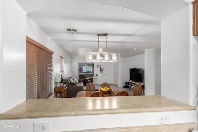 kitchen featuring visible vents, pendant lighting, and open floor plan