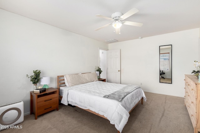 bedroom featuring visible vents, light colored carpet, and ceiling fan