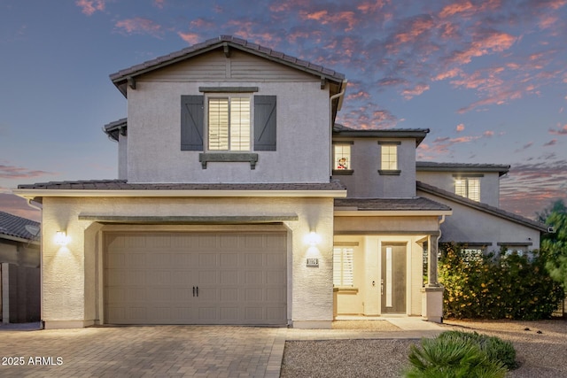 1076 E Kensington Rd, Gilbert, AZ 85297 - view of front facade featuring an attached garage, stucco siding, decorative driveway, and a tile roof