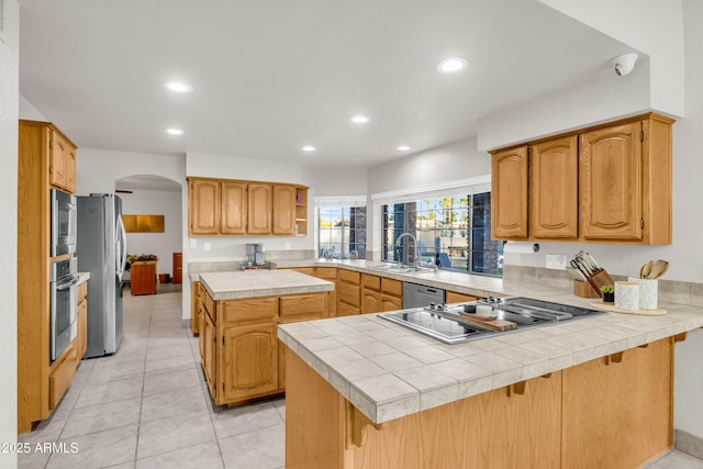 7763 W Libby St, Glendale, AZ 85308 - kitchen with stainless steel appliances, a peninsula, a sink, arched walkways, and open shelves