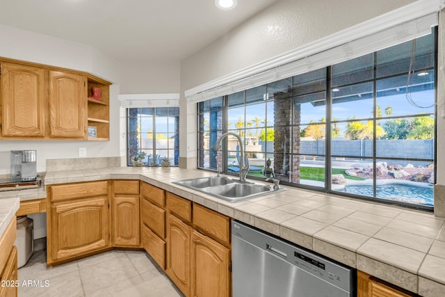 7763 W Libby St, Glendale, AZ 85308 - kitchen with stainless steel dishwasher, open shelves, tile counters, a sink, and light tile patterned flooring