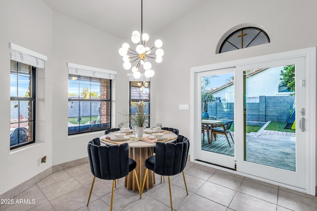7763 W Libby St, Glendale, AZ 85308 - dining room with a chandelier, vaulted ceiling, plenty of natural light, and light tile patterned floors