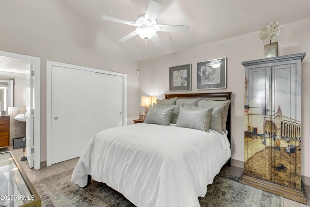 7763 W Libby St, Glendale, AZ 85308 - bedroom featuring ceiling fan, vaulted ceiling, light tile patterned floors, and a closet